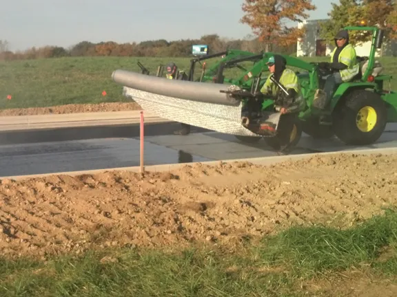 Paving fabric installed ahead of a concrete overlay