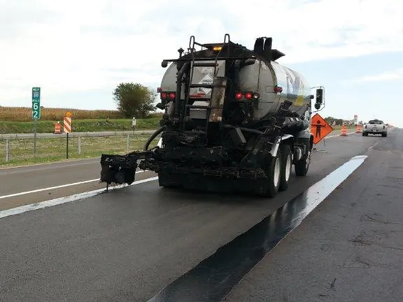 Tanker applying J-Band VRAM along a highway centerline joint
