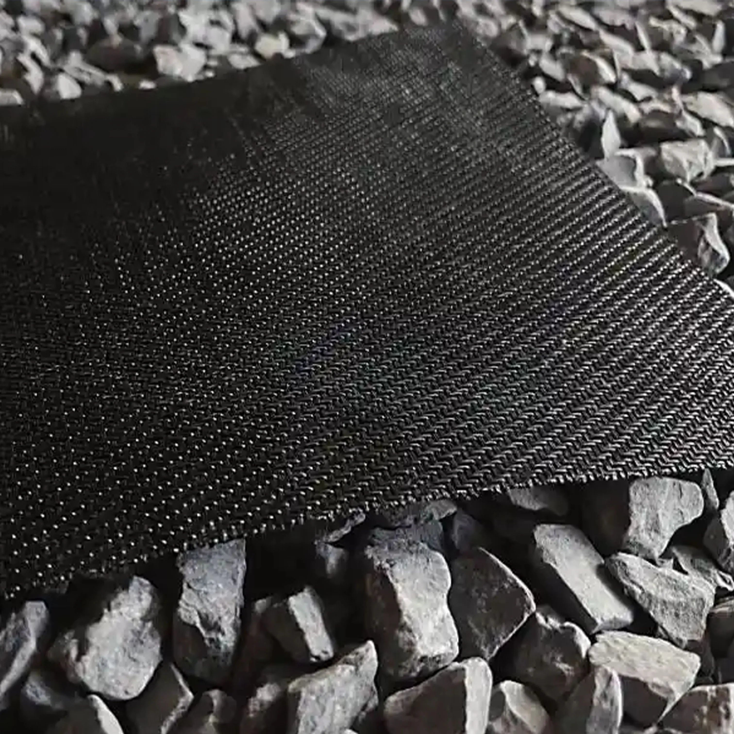 High strength woven geotextile over aggregate base